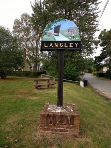 Photo of village sign when entering Langley